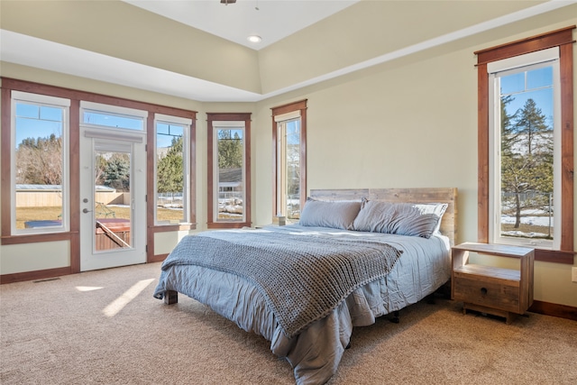 carpeted bedroom featuring access to outside, visible vents, and baseboards