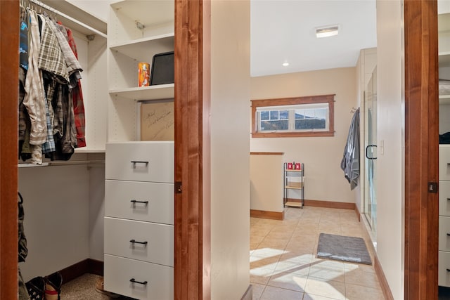 spacious closet featuring light tile patterned floors