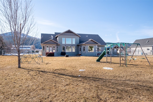 exterior space with board and batten siding and a playground