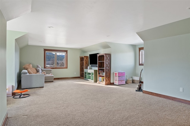 playroom with lofted ceiling, carpet, baseboards, and a wealth of natural light