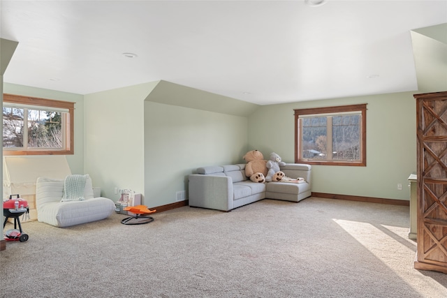 recreation room featuring vaulted ceiling, carpet, and baseboards