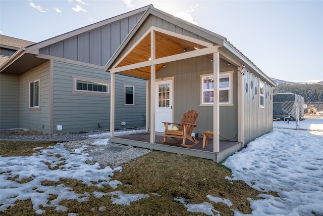 snow covered property featuring board and batten siding