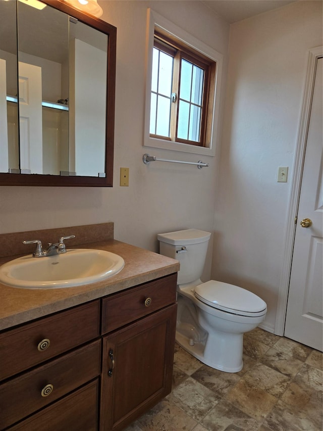 bathroom featuring toilet and vanity