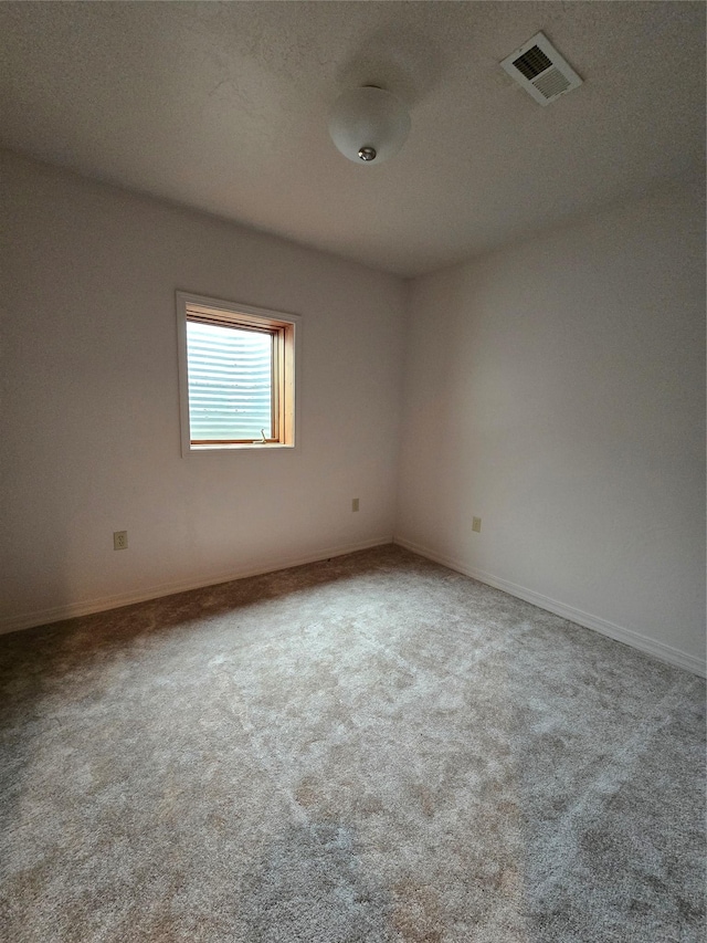 empty room with visible vents and carpet