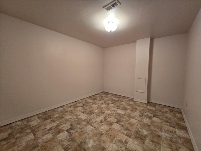 empty room with baseboards and visible vents