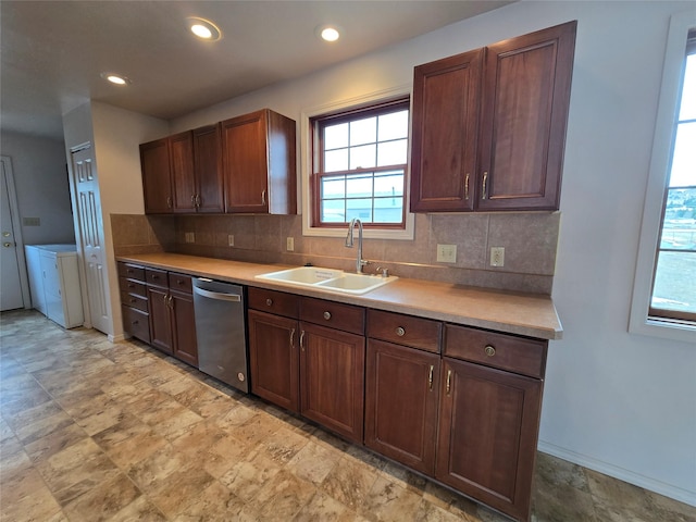 kitchen with stainless steel dishwasher, separate washer and dryer, tasteful backsplash, and a sink