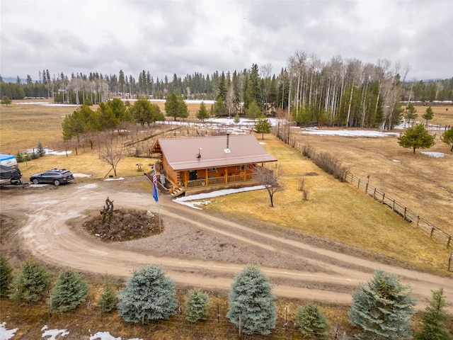 drone / aerial view featuring a rural view and a wooded view