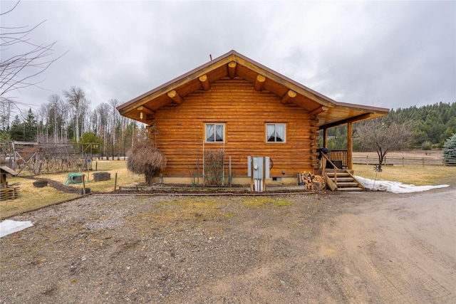 view of side of home featuring log siding