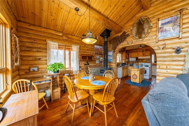 dining area with dark wood-style floors, beamed ceiling, wood ceiling, and a wood stove