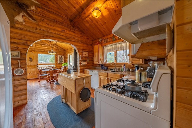 kitchen featuring lofted ceiling with beams, white appliances, arched walkways, and a wealth of natural light