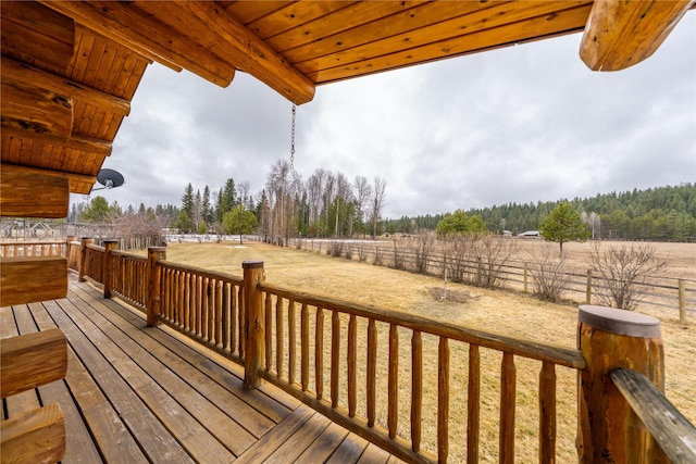 wooden deck featuring an enclosed area and a rural view