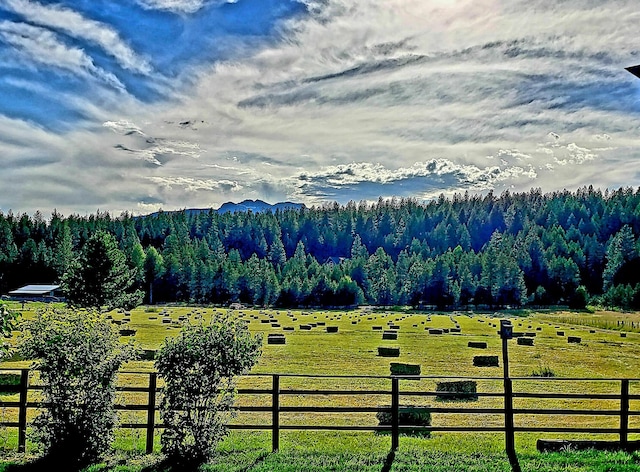 property view of mountains featuring a rural view and a view of trees