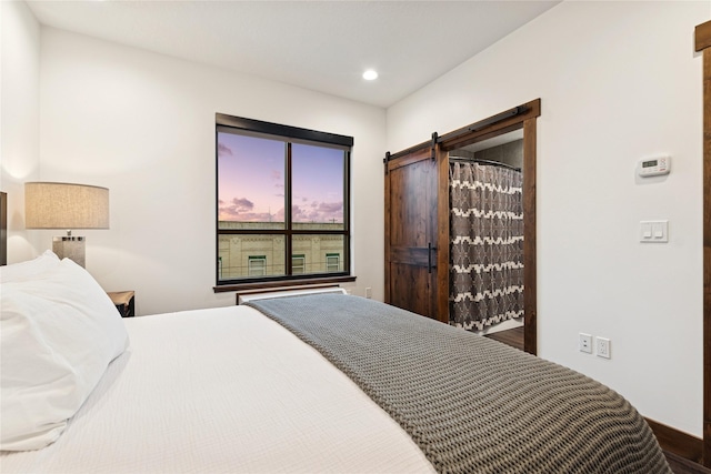 bedroom with recessed lighting and a barn door