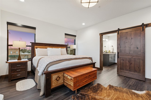 bedroom featuring recessed lighting, baseboards, dark wood-type flooring, and a barn door