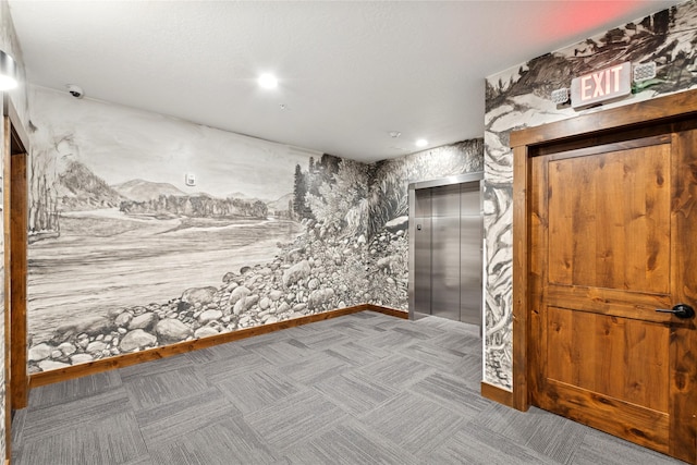 carpeted empty room featuring elevator