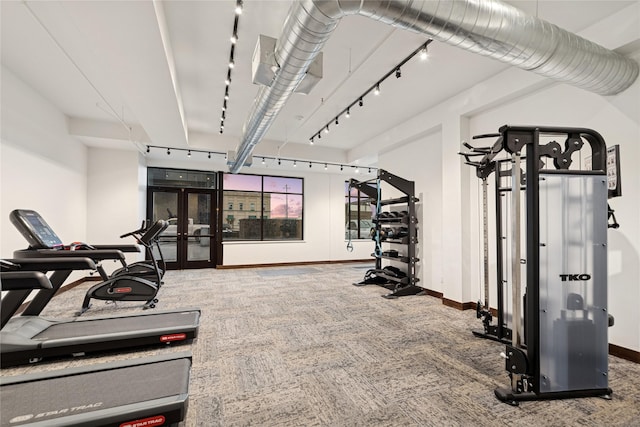 gym with french doors, carpet floors, baseboards, and rail lighting