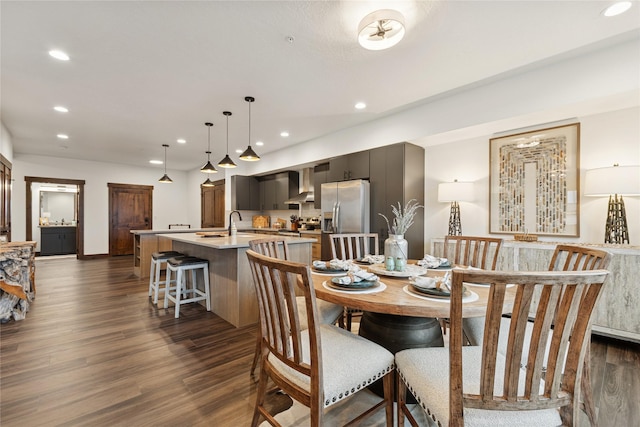 dining space with recessed lighting and dark wood finished floors