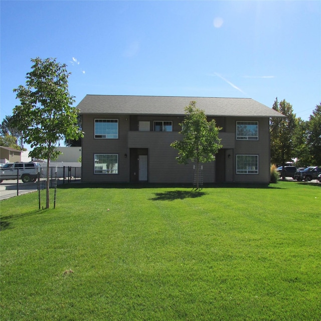 view of front of property with a front yard and fence