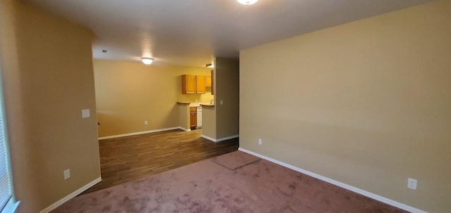 interior space featuring dark carpet and baseboards