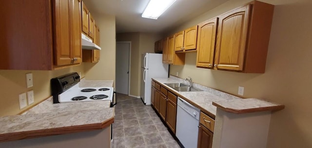 kitchen featuring under cabinet range hood, white appliances, light countertops, and a sink