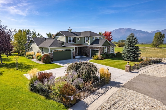 shingle-style home featuring fence, stone siding, and driveway