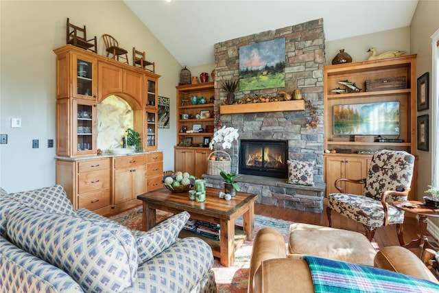 living room with a fireplace, lofted ceiling, and wood finished floors