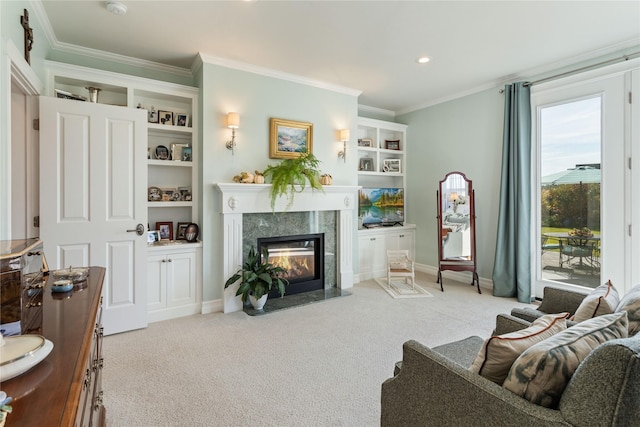 carpeted living room featuring built in features, baseboards, ornamental molding, and a fireplace