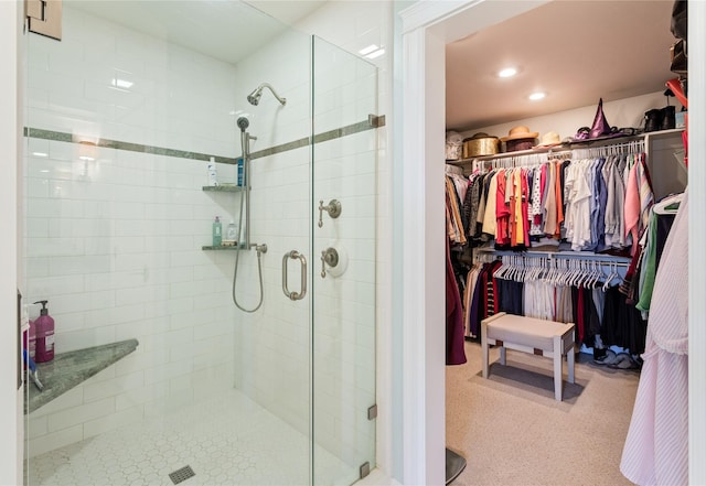 full bath with a walk in closet, a shower stall, and recessed lighting