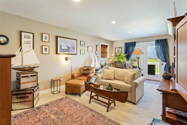 living room with recessed lighting, light colored carpet, and baseboards