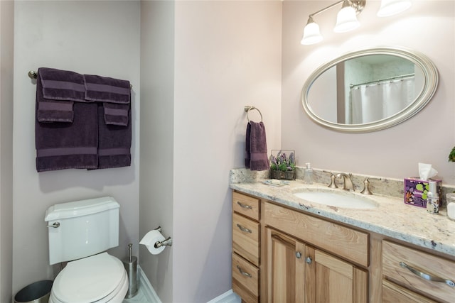 bathroom with toilet and vanity