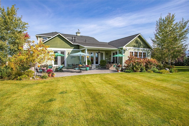 back of house with a yard, a patio area, and french doors