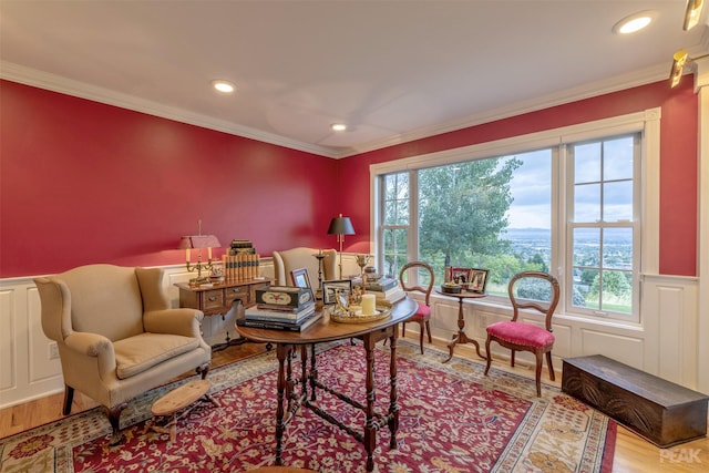 living area with crown molding, plenty of natural light, and wood finished floors