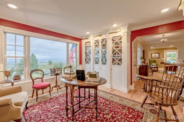 living area featuring recessed lighting, wood finished floors, baseboards, and ornamental molding