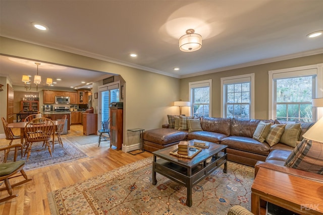 living room with recessed lighting, light wood-type flooring, baseboards, and ornamental molding