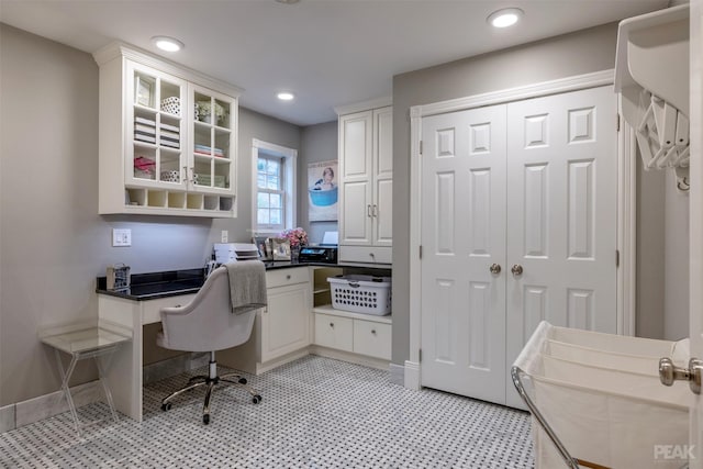 office with built in desk, recessed lighting, light floors, and baseboards