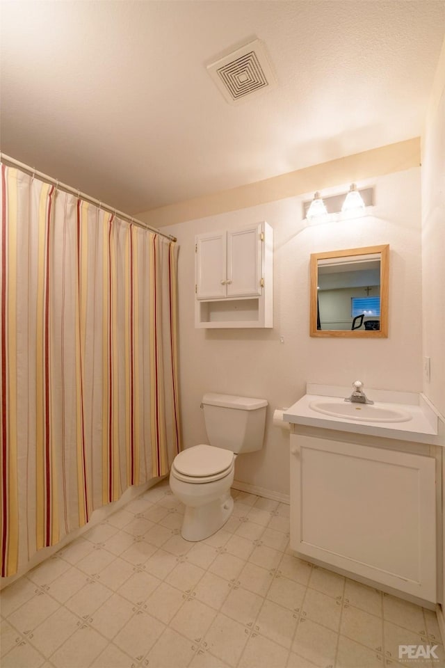 bathroom with tile patterned floors, visible vents, toilet, and vanity