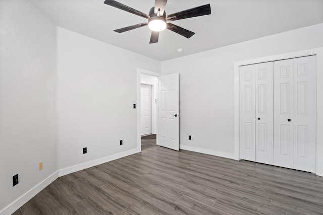 unfurnished bedroom with wood finished floors, baseboards, a closet, and ceiling fan