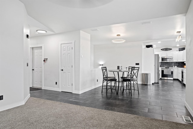 dining room featuring visible vents and baseboards