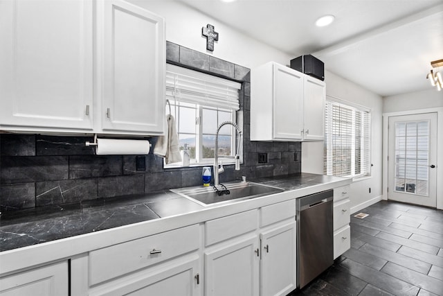 kitchen featuring a sink, backsplash, white cabinetry, baseboards, and dishwasher