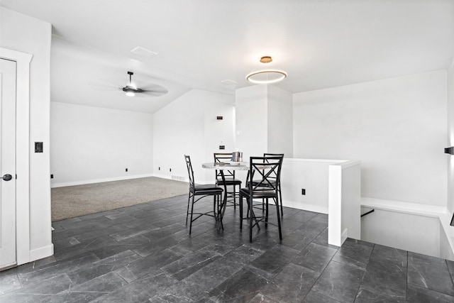 dining area with a ceiling fan and vaulted ceiling