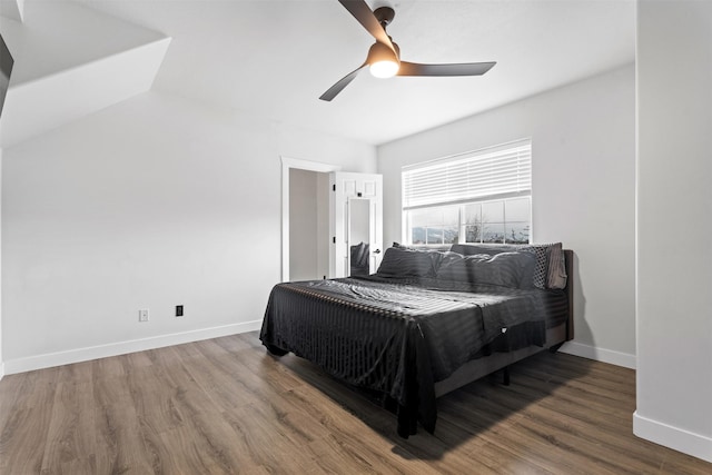 bedroom with wood finished floors, baseboards, and ceiling fan