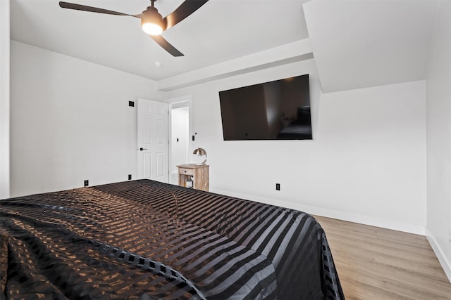 bedroom featuring a ceiling fan, wood finished floors, and baseboards