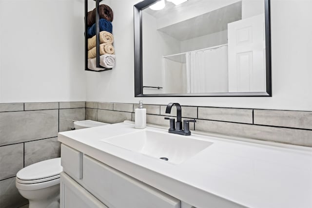 bathroom featuring vanity, tile walls, toilet, and a shower with curtain