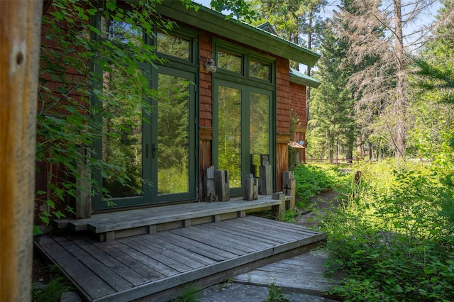 view of side of home with french doors and a wooden deck