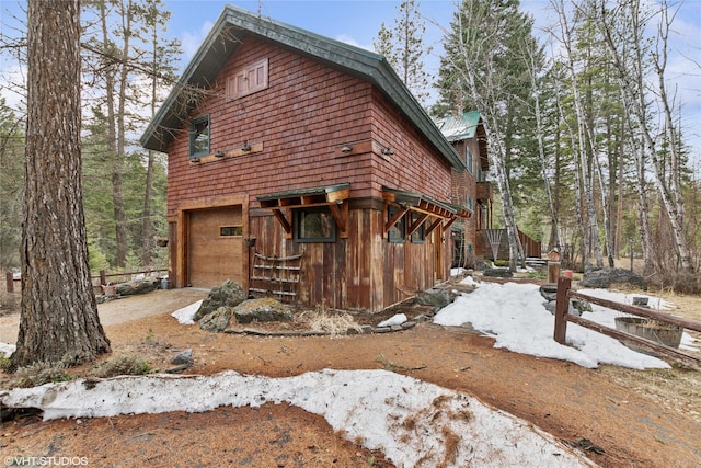 view of property exterior with an attached garage