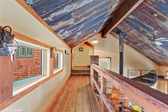 hall featuring vaulted ceiling with beams and wood-type flooring