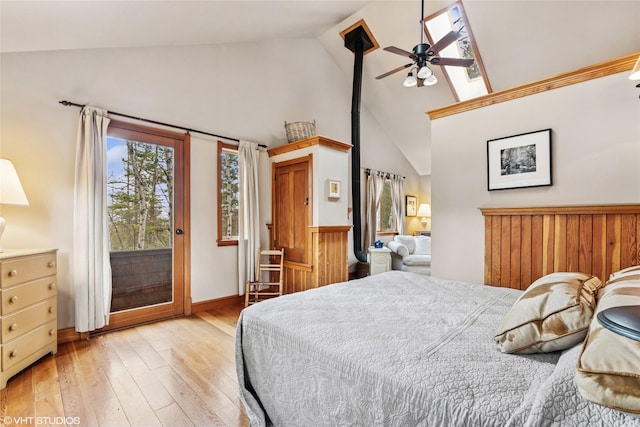 bedroom with access to outside, light wood-type flooring, and high vaulted ceiling