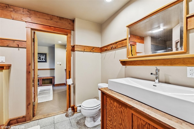 half bathroom with toilet and vanity