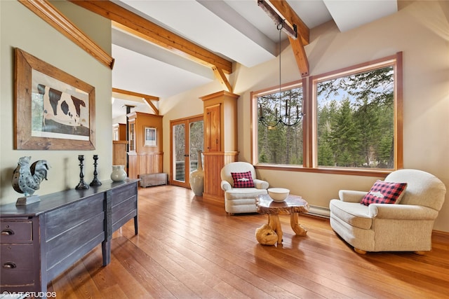 588 Ranch Rd, Bigfork, MT 59911 - sitting room with beam ceiling, decorative columns, hardwood / wood-style flooring, and a baseboard radiator