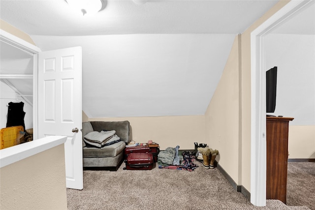 interior space with carpet flooring, baseboards, and lofted ceiling